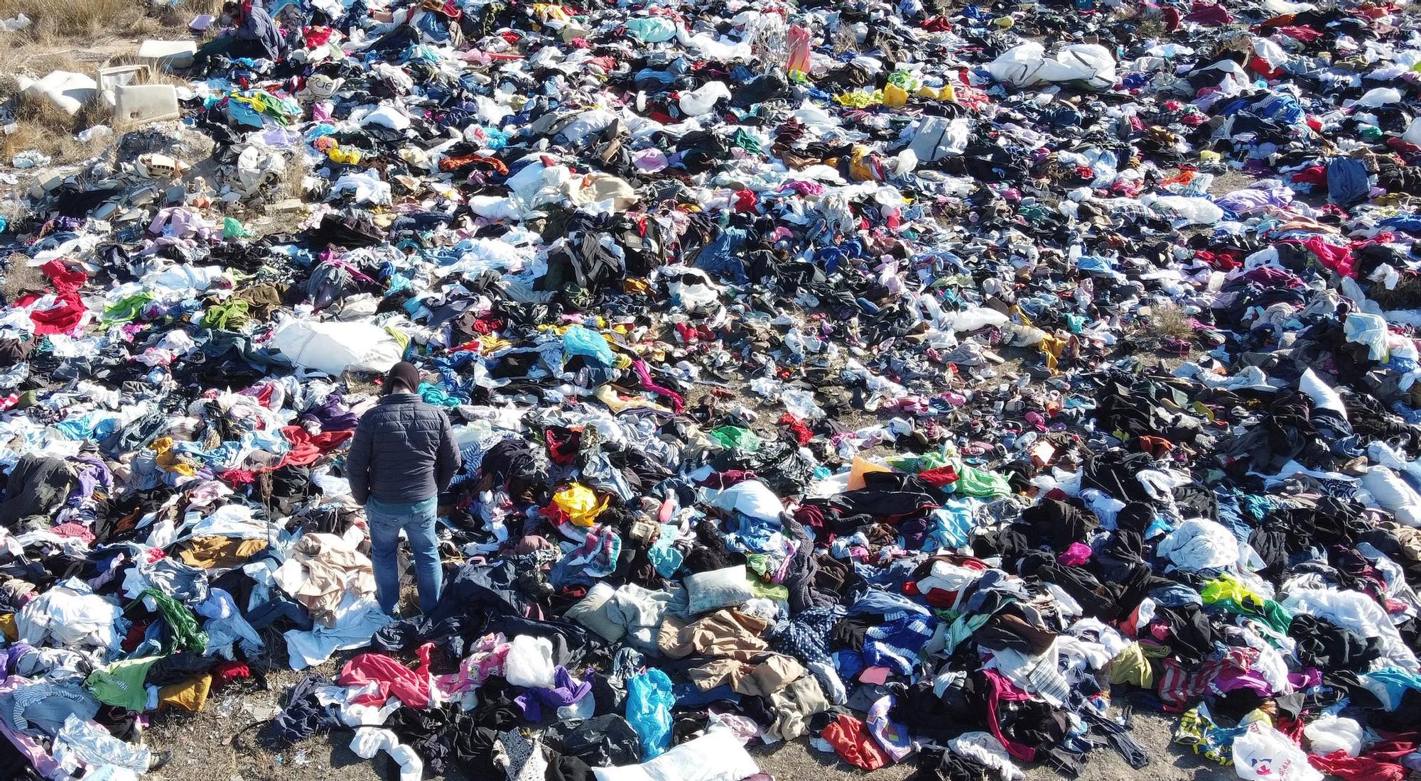 Explanada de ropa usada en un terreno de Rabasa en Alicante