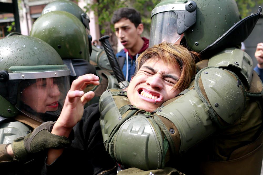 A demonstrator is detained during a rally to ...