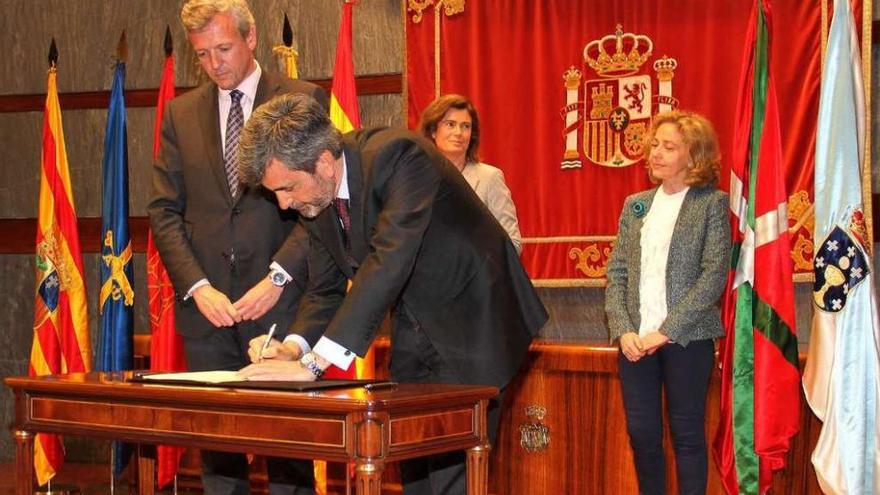 Rueda, de pie, junto al presidente del CGPJ durante la firma del convenio de mediación en Madrid.