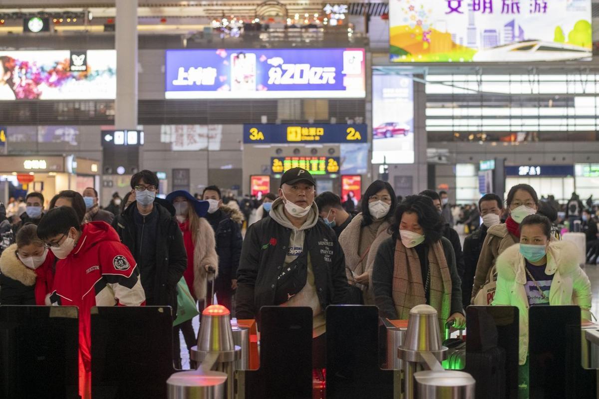 January 27, 2019 - Shanghai, China: Commuters wear face masks in wake of the coronavirus outbreak as they queue at the boarding gate for a high speed train to Nanning, Guangxi Province. Hongqiao Railway Station was unusually quiet as many residents stayed indoors to avoid contracting the virus. The Chinese government took the unprecedented step of quarantining the entire city of Wuhan (population around 11 million) in an effort to stop the spread of the coronavirus beyond the city of its origin. There are fears that the coronavirus may spread through out China and beyond during the Chinese Lunar New Year holidays - the world’s largest annual migration. Chinese citizens were expected to make around 3 billion trips over the 40 day holiday period. (Dave Tacon/Polaris)