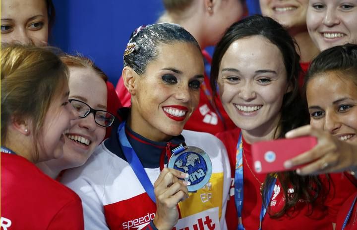 Silver medal winner Ona Carbonell of Spain makes a selfie with volunteers after the synchronised swimming solo technical final at the Aquatics World Championships in Kazan