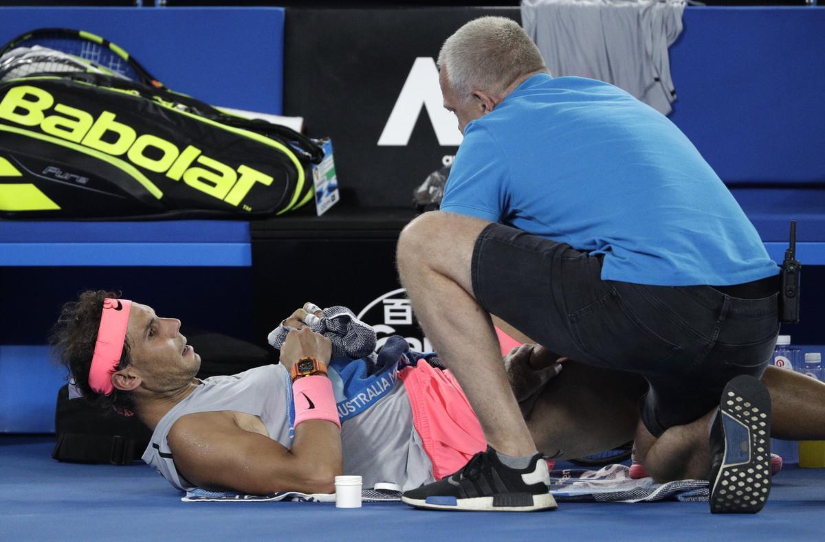 Spain’s Rafael Nadal receives treatment from a trainer during his quarterfinal against Croatia’s Marin Cilic at the Australian Open tennis championships in Melbourne, Australia, Tuesday, Jan. 23, 2018. (AP Photo/Dita Alangkara)