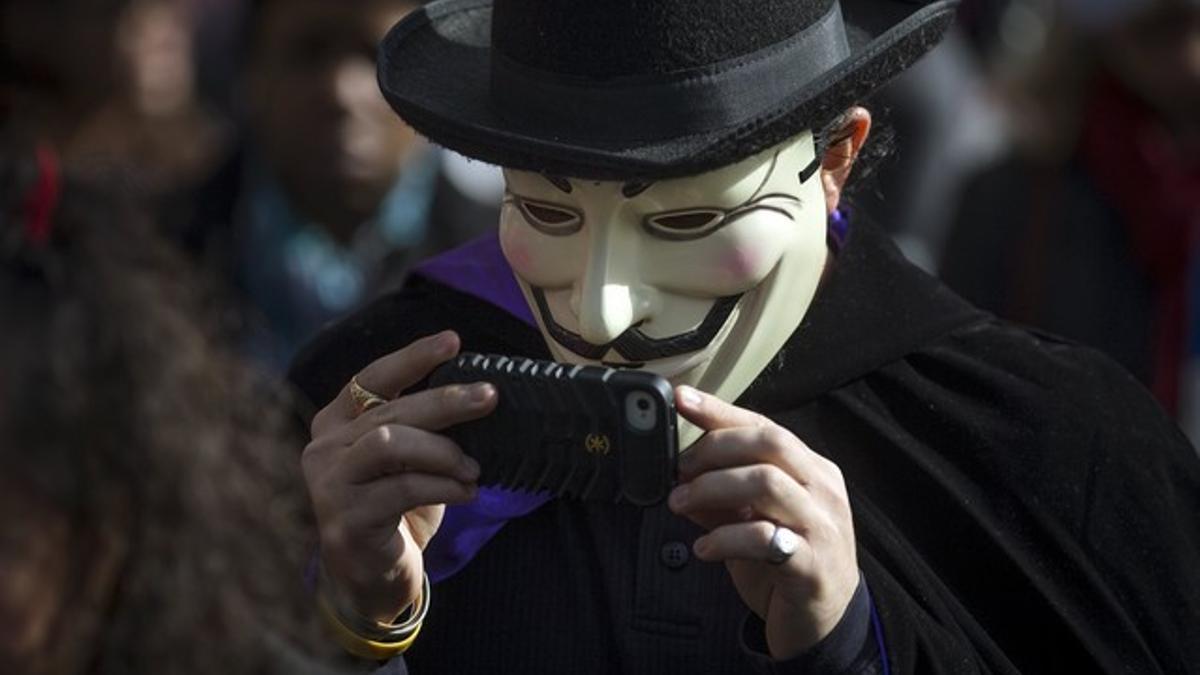 Person dressed in a Guy Fawkes mask takes part in the Children's Halloween day parade at Washington Square Park in the Manhattan borough of New York