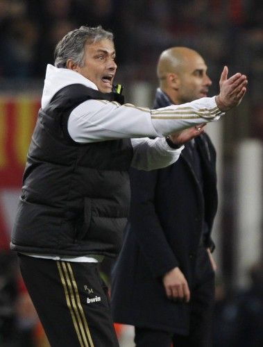 Real Madrid's coach Mourinho reacts in front of Barcelona's coach Guardiola during their Spanish King's Cup soccer match in Barcelona