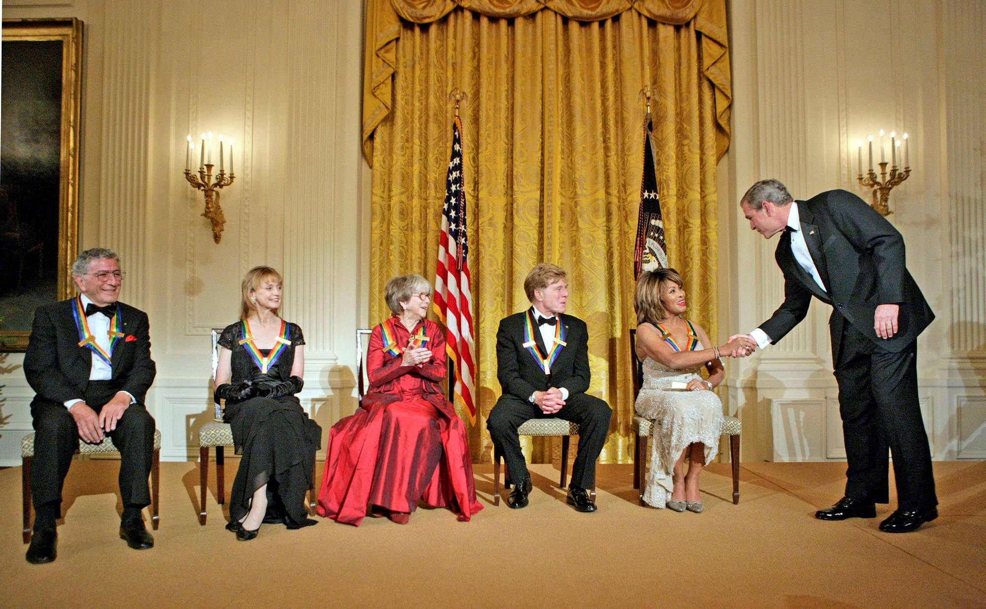 FILE PHOTO: U.S. President George W. Bush congratulates singer Tina Turner during a reception for the Kennedy Center Honors in the East Room of the White House in Washington