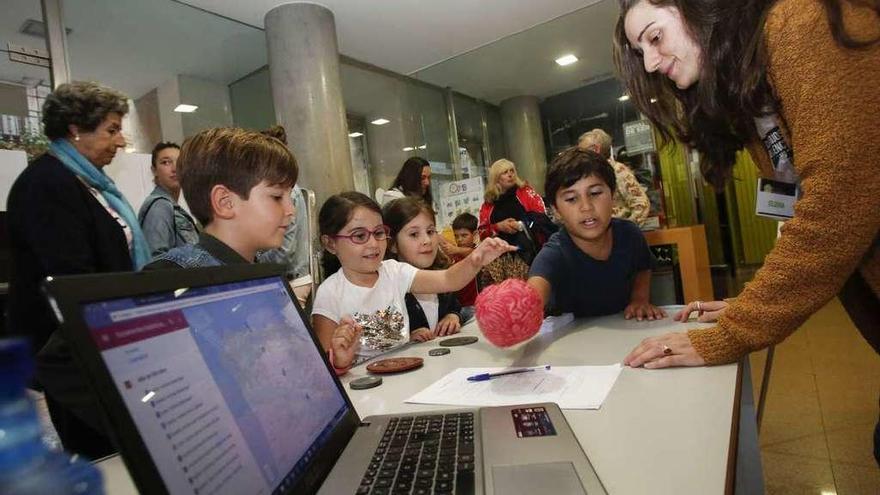 Por la izquierda, Manuel González, Ana Fernández, Ángela González y Javier Fernández, con la investigadora Elena Albarrán, en el puesto &quot;Los lectores de letras antiguas&quot;.