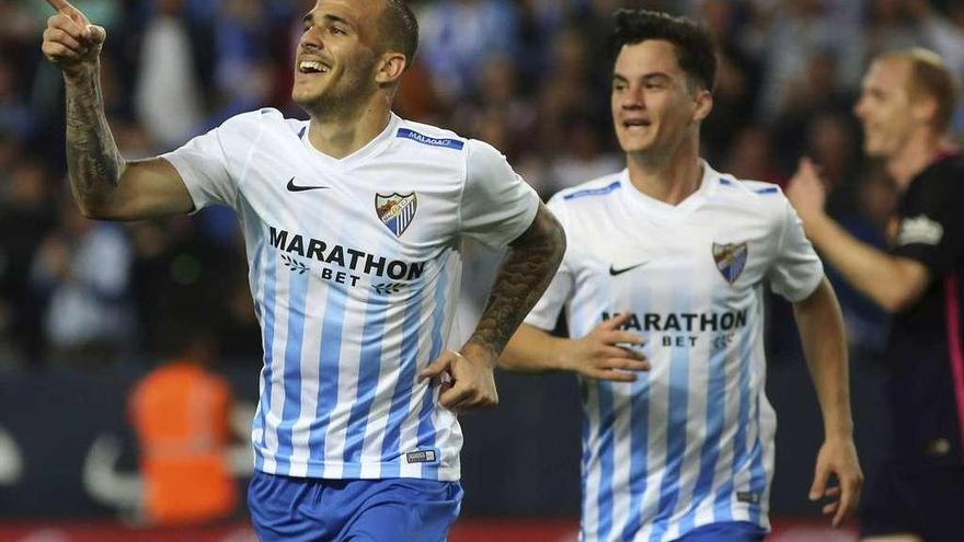 Sandro Ramírez celebra el primer gol del Málaga al Barcelona con su compañero Juanpi Amor, anoche en La Rosaeda. // Efe