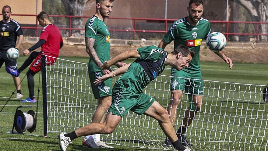 Los futbolistas del Elche, ayer, jugando al fútbol-tenis en el entrenamiento.