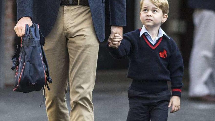 El príncipe Jorge, de la mano de su padre, ayer, camino del colegio.