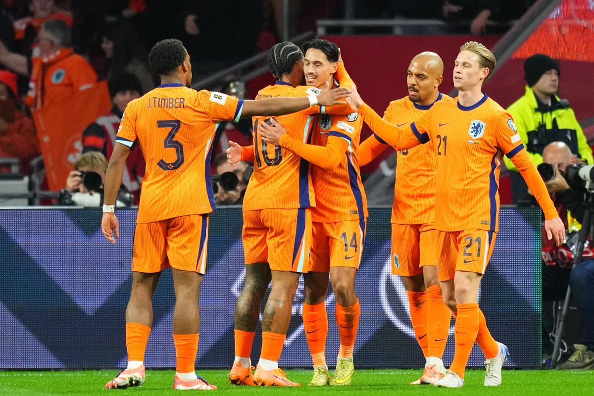 Netherlands' Tijjani Reijnders (14) is congratulated after scoring his side's opening goal during a World Cup 2026 group G qualifying soccer match between Netherlands and Lithuania in Amsterdam, Netherlands, Monday, Nov. 17, 2025. (AP Photo/Peter Dejong)