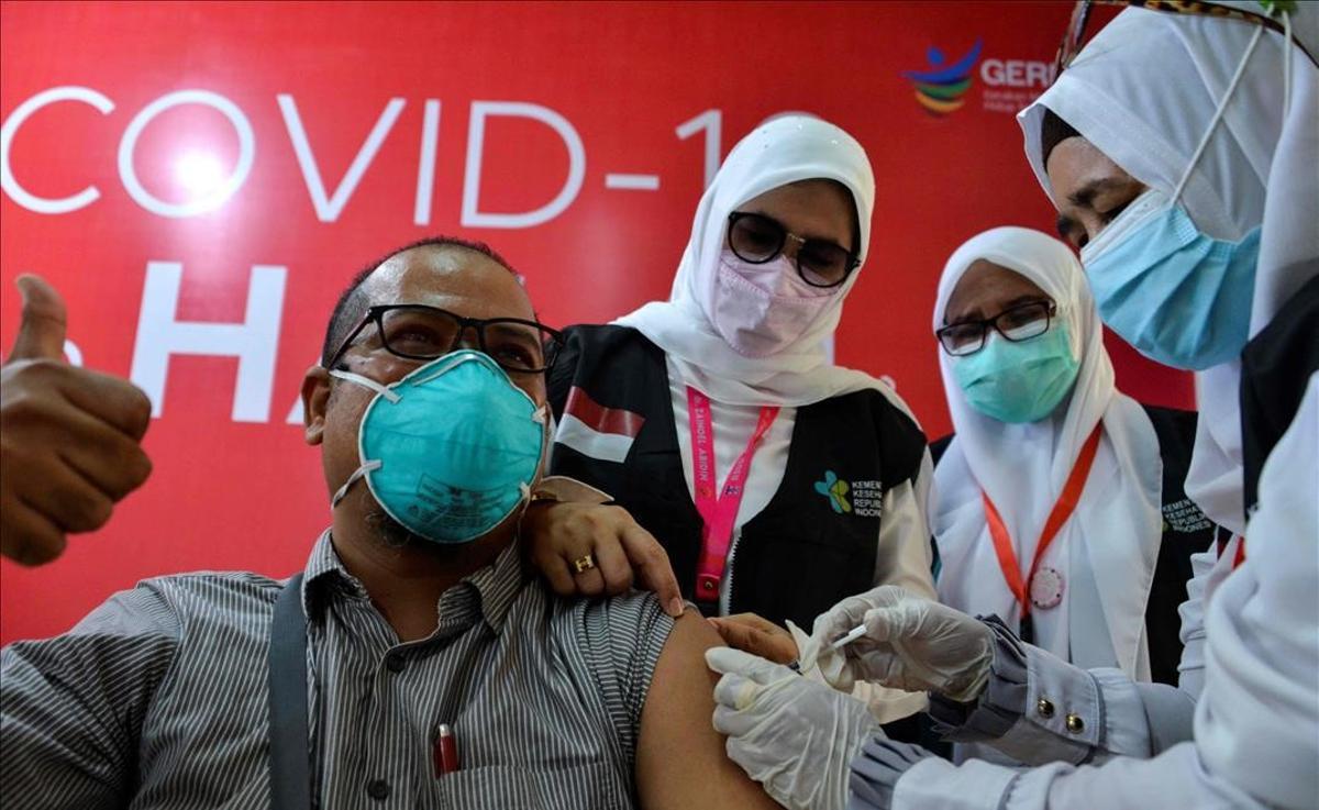 Sanitarios administran la vacuna Sinovac para el covid a un doctor, en el Hospital Zainoel Abidin, en Banda Aceh, Indonesia.
