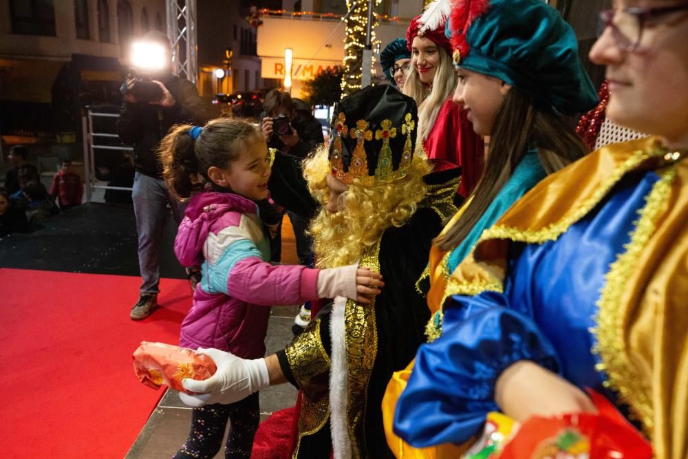 Los Reyes Magos, escoltados por pajes reales y bailarinas, reparten entre el público 800 kilos de caramelos y gominolas