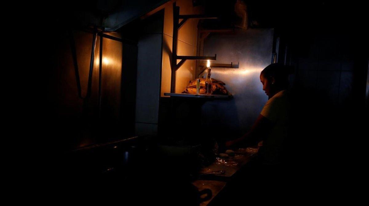 zentauroepp47523381 a woman uses the light of a makeshift lantern to work at the190327161400