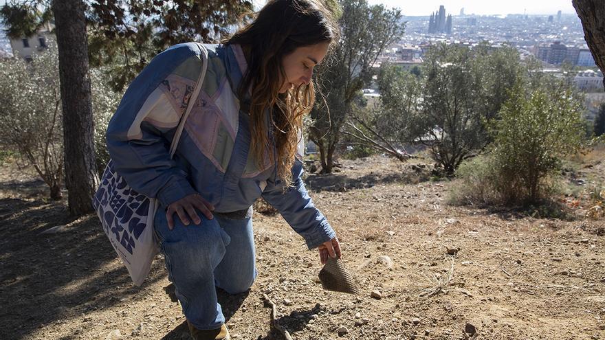 Una vecina muestra restos de Uralita en una ladera del Parque del Guinardó, muy cerca de los búnkeres del Carmel.