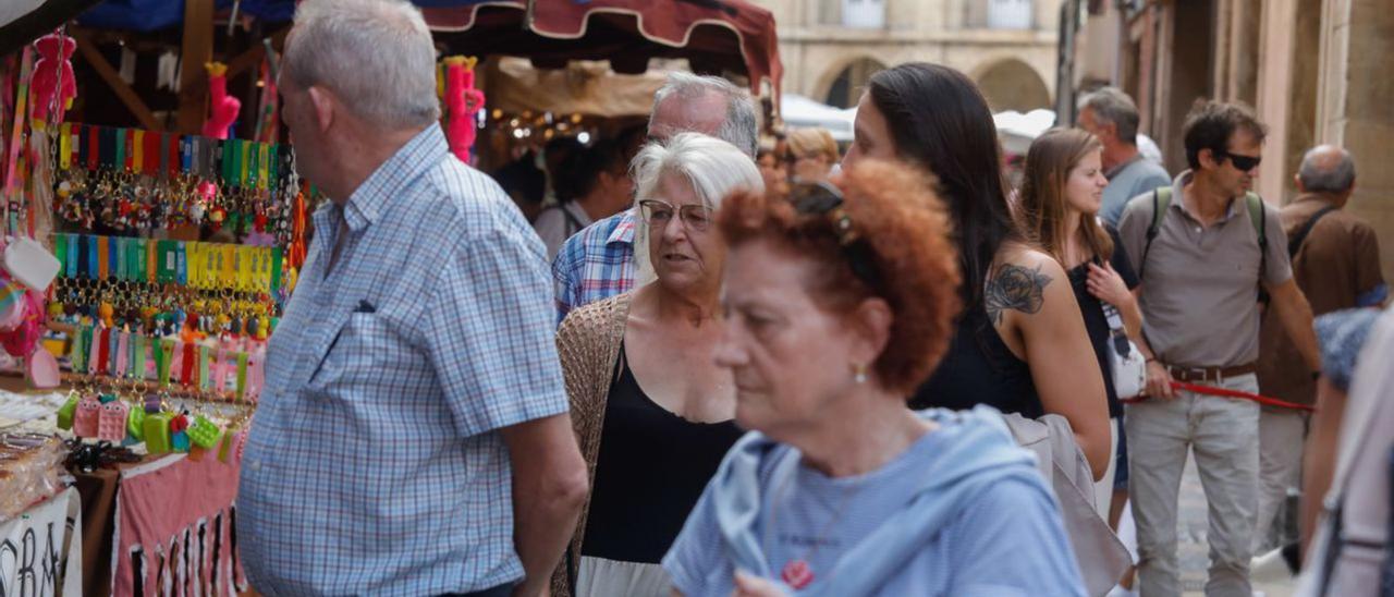 Tres imágenes de la ambientación, ayer, en el mercado medieval en el casco histórico  de Avilés. | Mara     Villamuza |