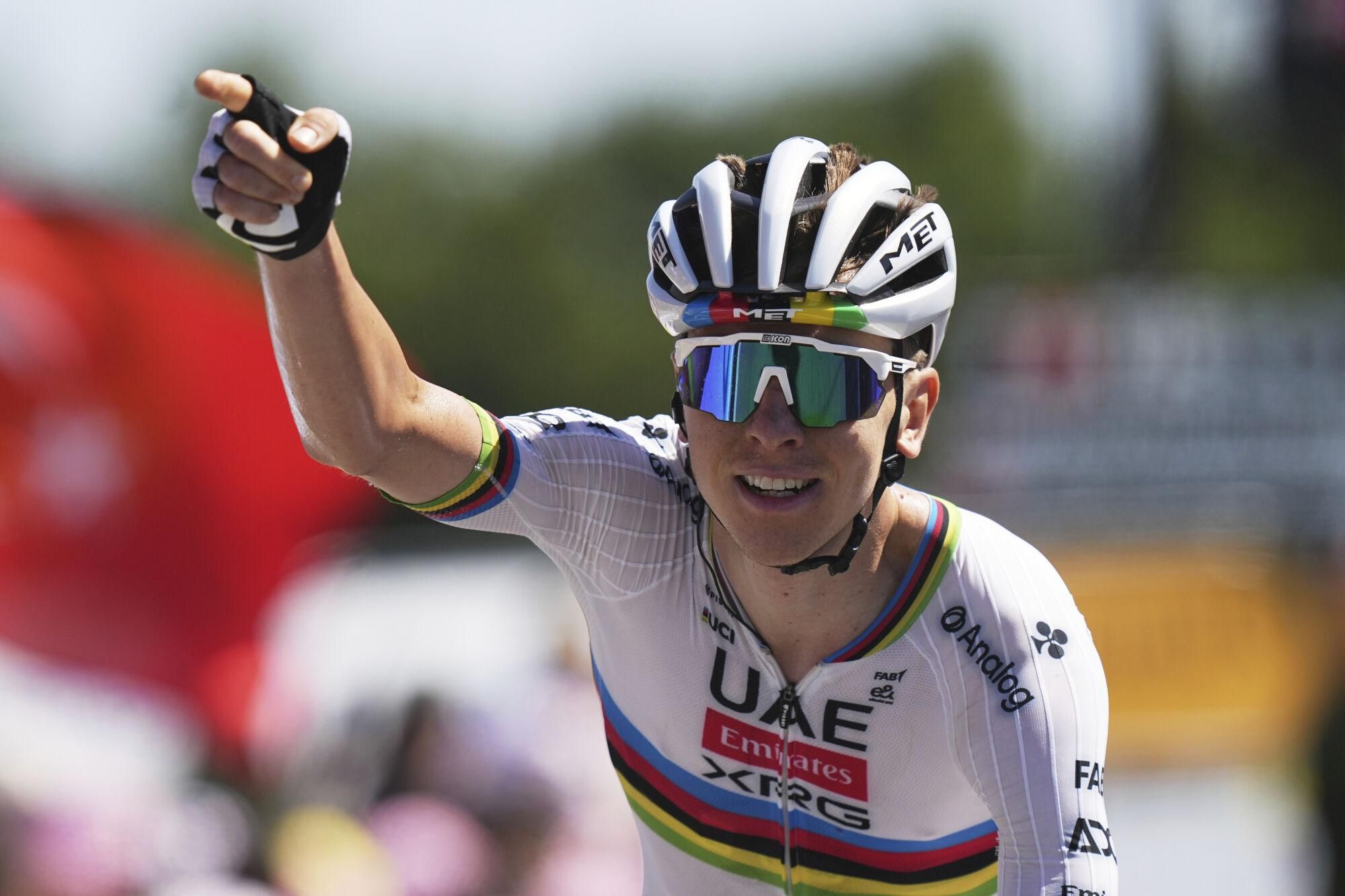 Slovenia's Tadej Pogacar celebrates as he crosses the finish line to win the seventh stage of the Tour de France cycling race over 197 kilometers (122.4 miles) with start in Saint-Malo and finish in Mur-de-Bretagne Guerledan, France, Friday, July 11, 2025. (AP Photo/Thibault Camus). EDITORIAL USE ONLY/ONLY ITALY AND SPAIN