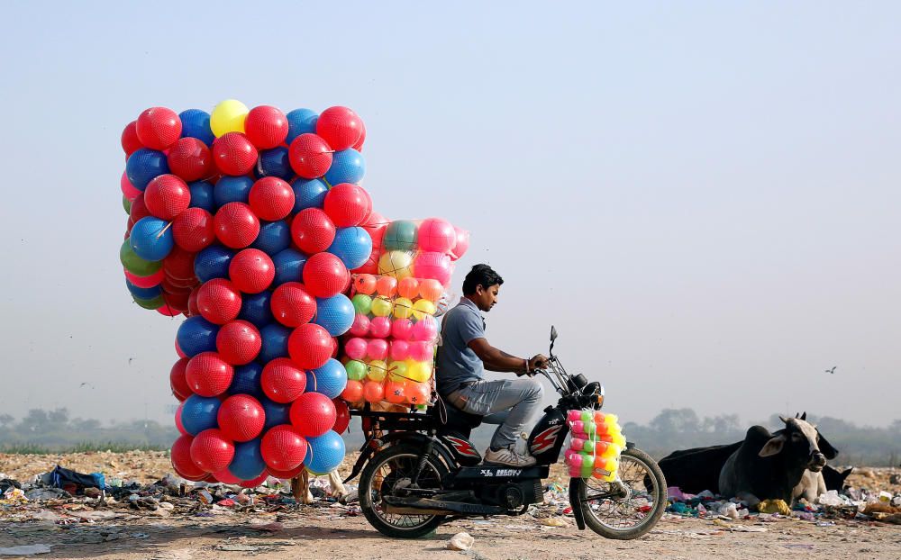 A man carries children's coloured plastic balls ...