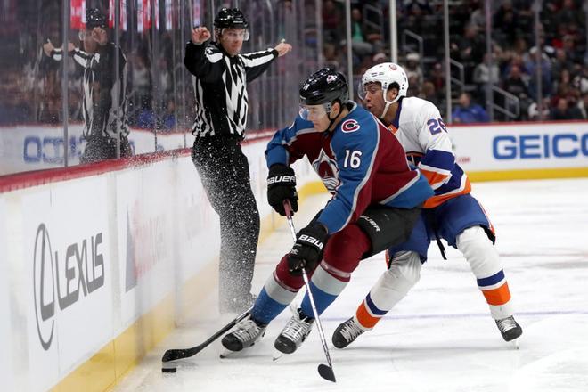 Nikita Zadorov # 16 de Colorado Avalanche lucha por el disco contra Joshua Ho-Sang # 26 de los New York Islanders en el tercer período en el Pepsi Center en Denver, Colorado.
