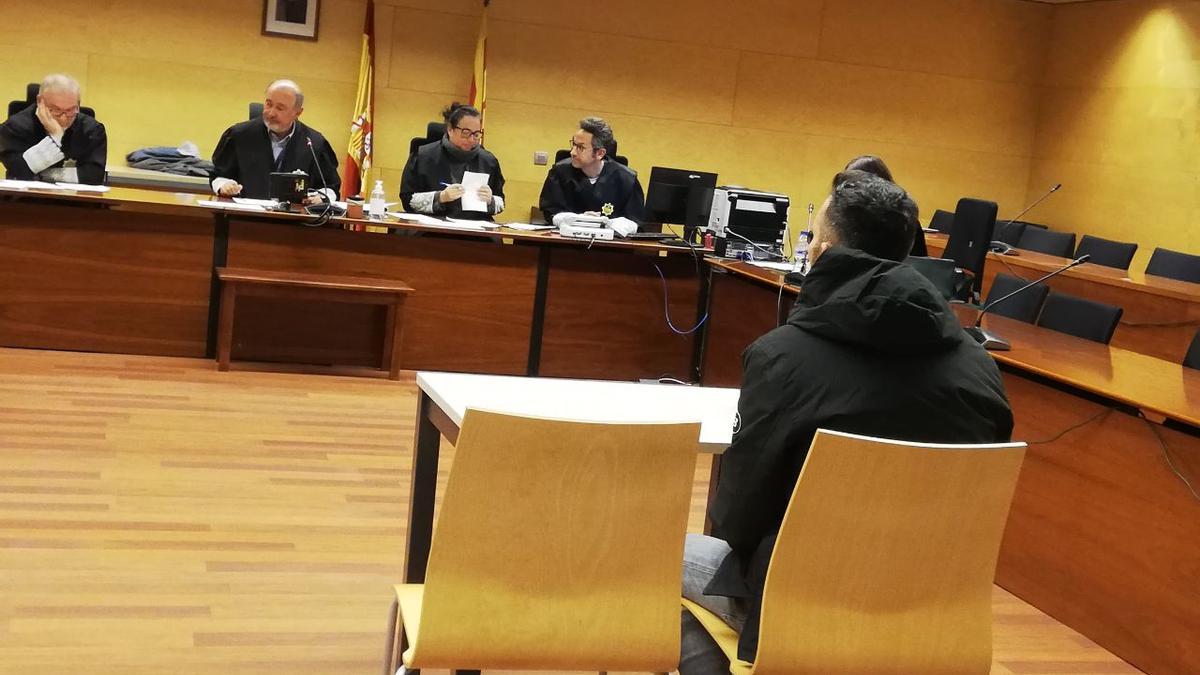 L'acusat, d'esquenes, durant el judici a l'Audiència de Girona.