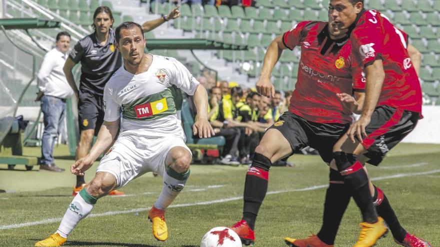 Bustos y el jugador del Elche, Collantes, pugnan por el balón durante el partido del domingo en el Martínez Valero.