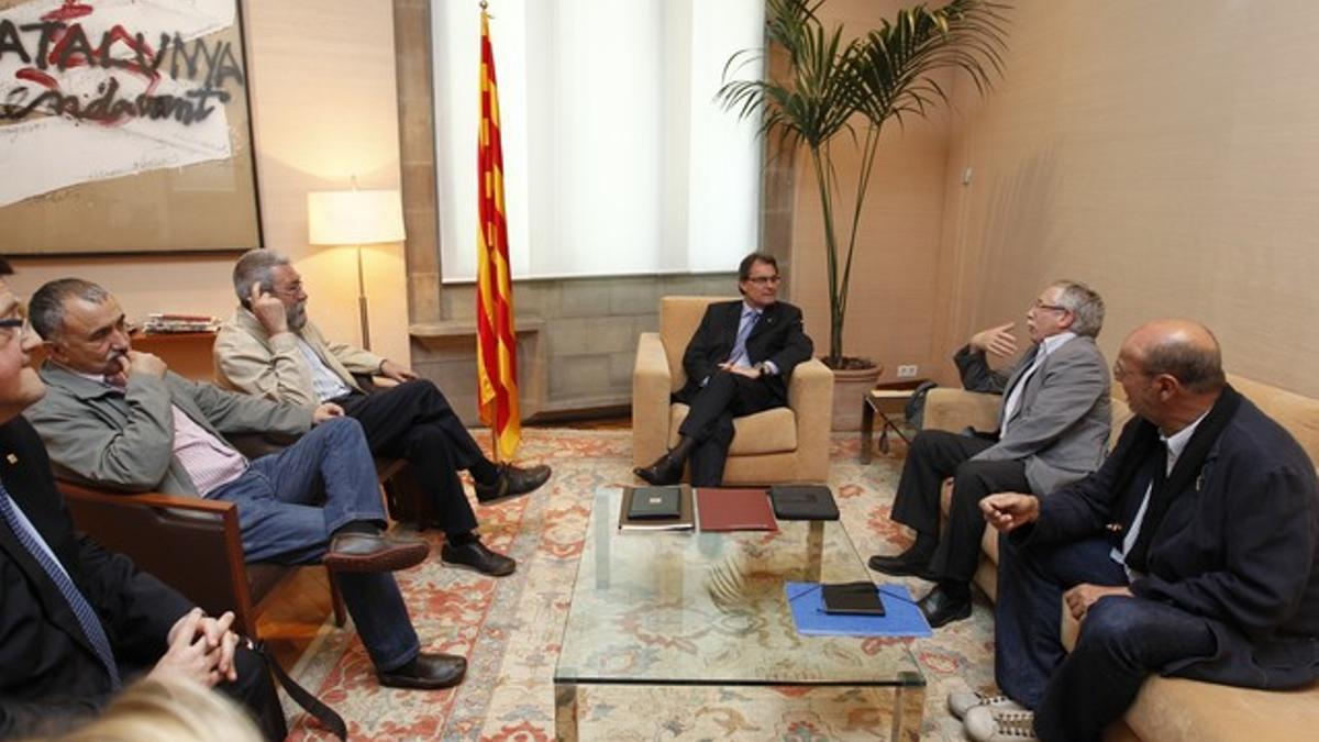 Artur Mas, en el centro, con los líderes de CCOO y UGT, este lunes en el Palau de la Generalitat.