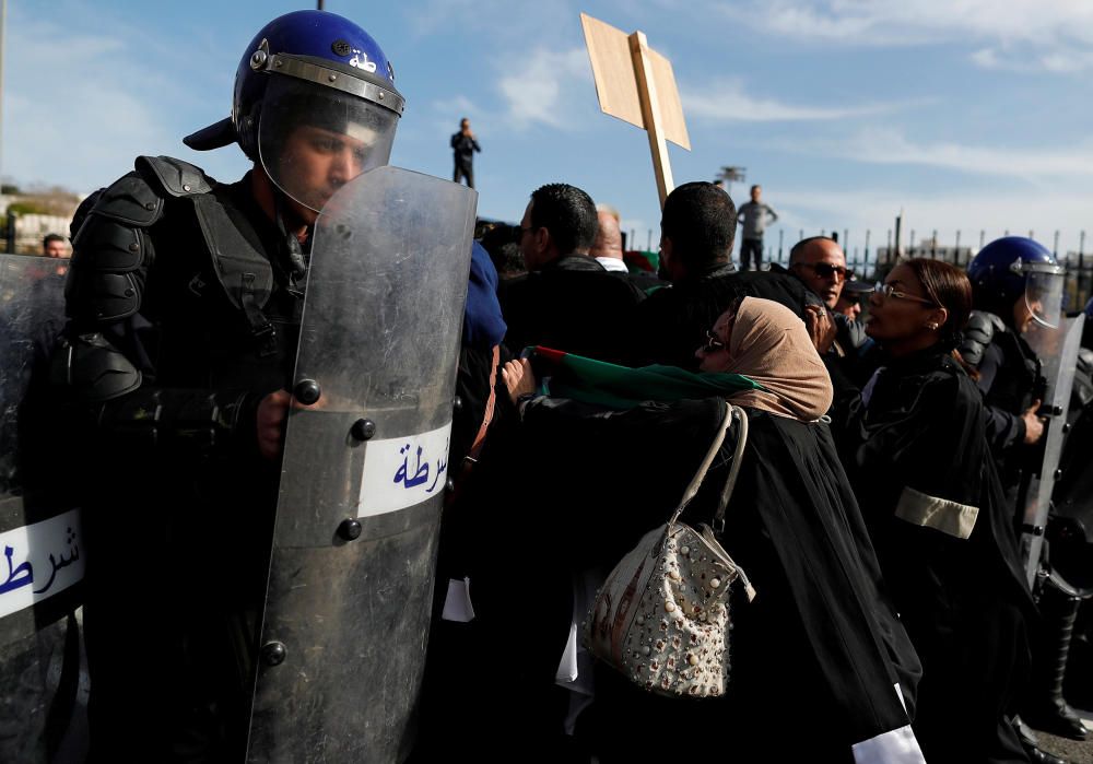 Police members stand guard as lawyers protest to ...