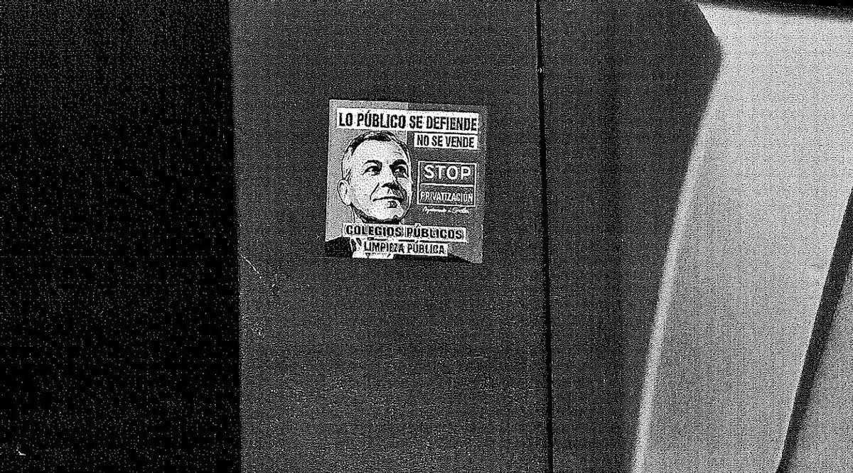 Pegatina colocada en un contenedor en contra del alcalde, José Luis Sanz, a raíz de la privatización de la limpieza de los colegios públicos