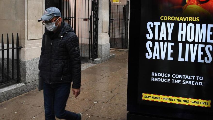 Un hombre con mascarilla en una calle de Londres. Un hombre con mascarilla en una calle de Londres.