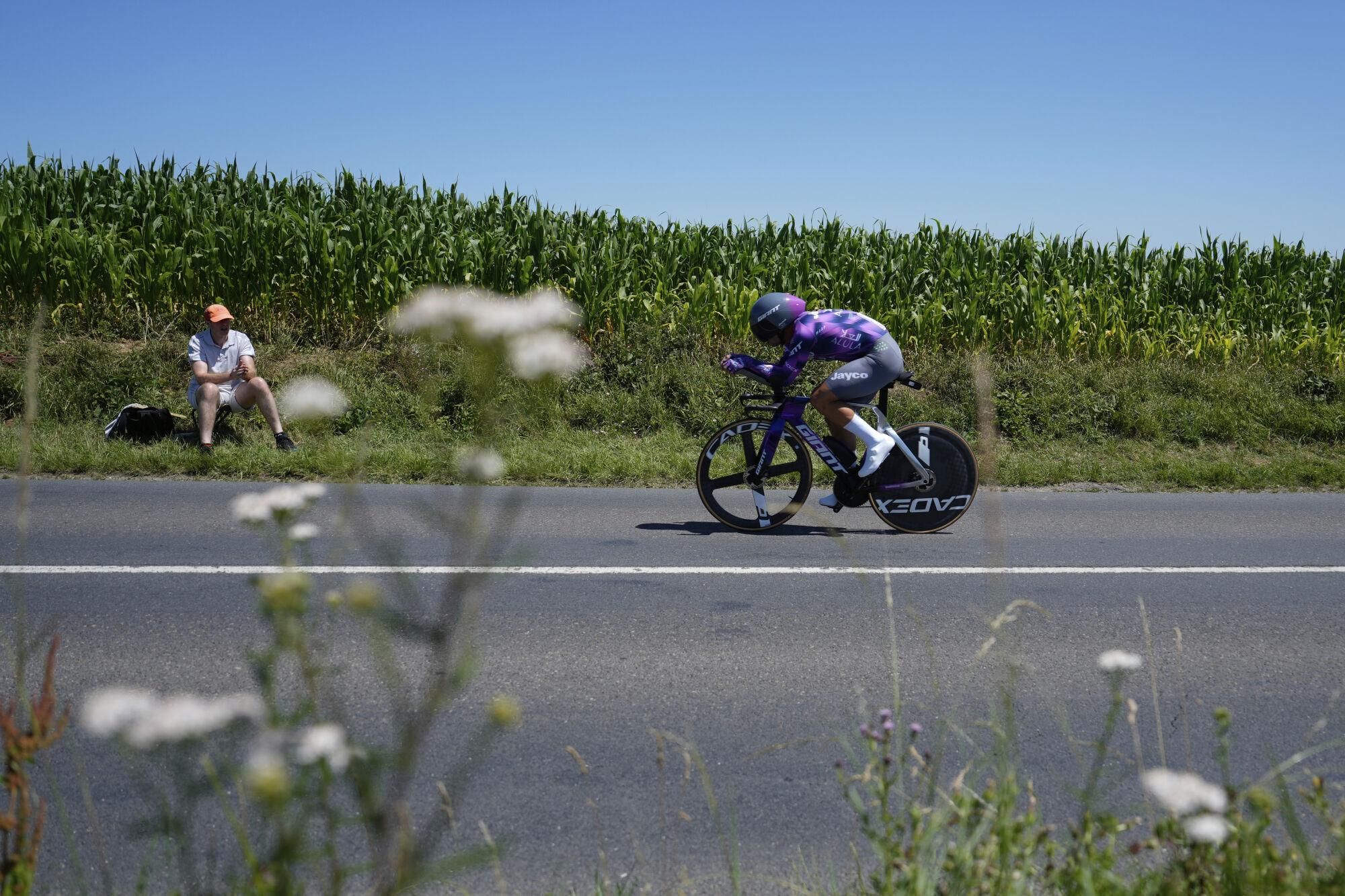A man watches Netherlands' Dylan Groenewegen during the fifth stage of the Tour de France cycling race, an indivdual time-trial over 33 kilometers (20.5 miles) with start and finish in Caen, France, Wednesday, July 9, 2025. (AP Photo/Mosa'ab Elshamy)