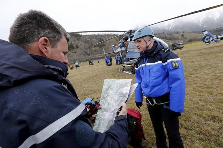 French Police and Gendarmerie Alpine rescue units gather on a field as they prepare to reach the crash site of an Airbus A320