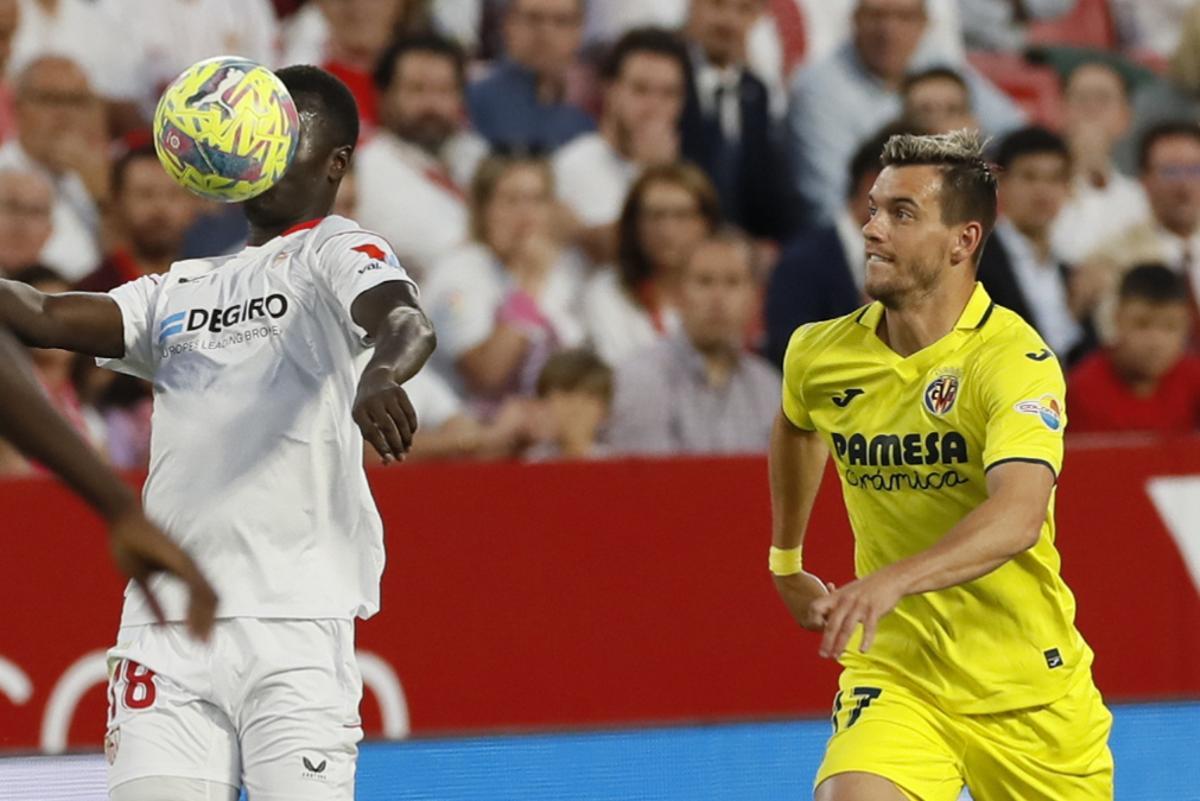 Lo Celso disputa el balón ante el futbolista del Sevilla.