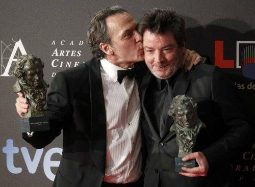 Spanish actor Jose Coronado kisses director Enrique Urbizu backstage at the Spanish Film Academy's Goya awards ceremony in Madrid