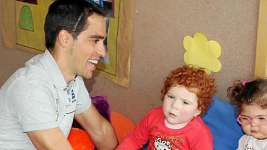 Contador junto a dos niñas del centro