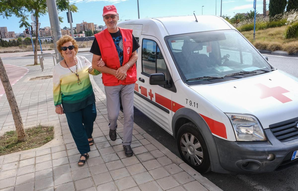 Un voluntario de Cruz Roja acompaña a Nieves García a uno de los talleres de manualidades a los que asiste junto a sus nuevas amigas.