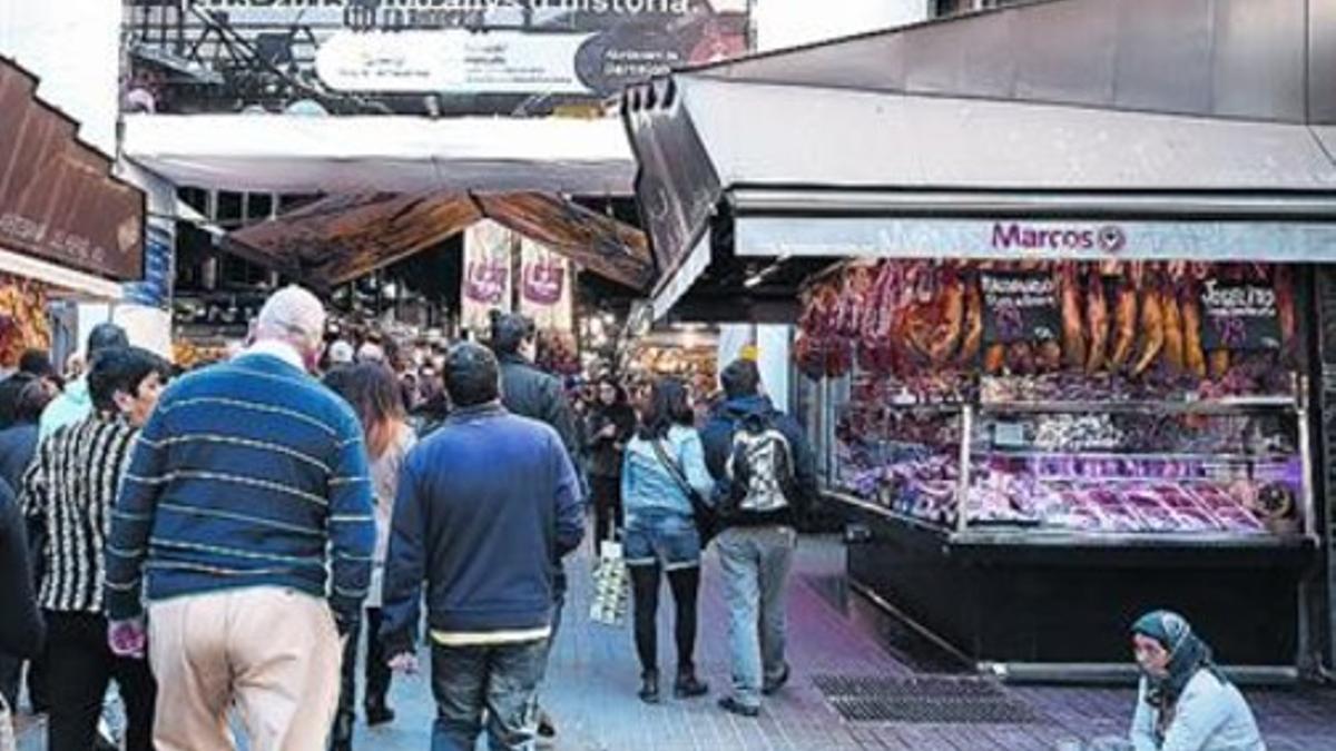 Una mujer pide limosna en la Boqueria, el 15 de noviembre.