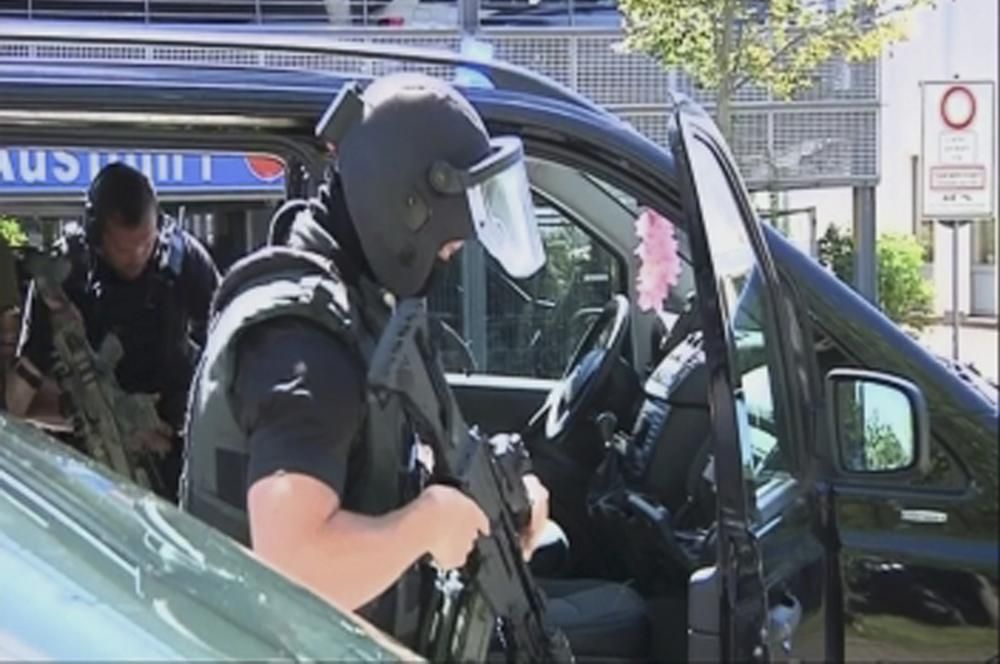 German special police leave their cars after a ...