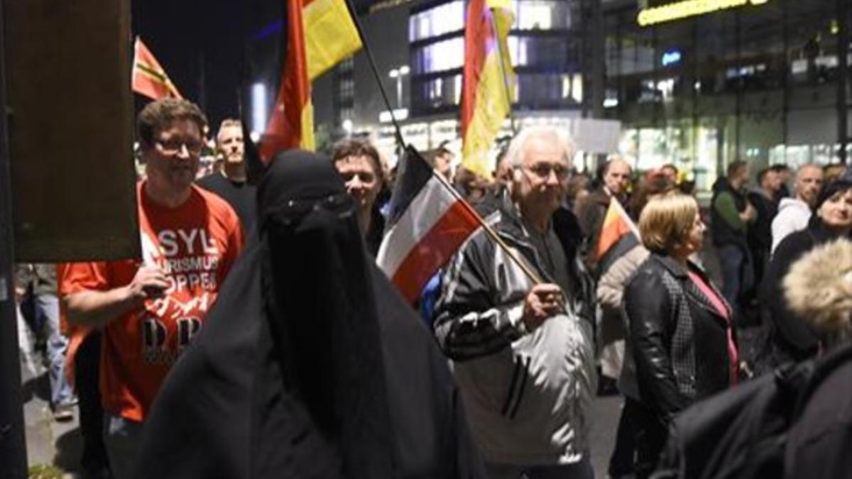 Protesta organizada por Pegida, en la que uno de los manifestantes lleva un supuesto burka, el lunes, en Dresde.