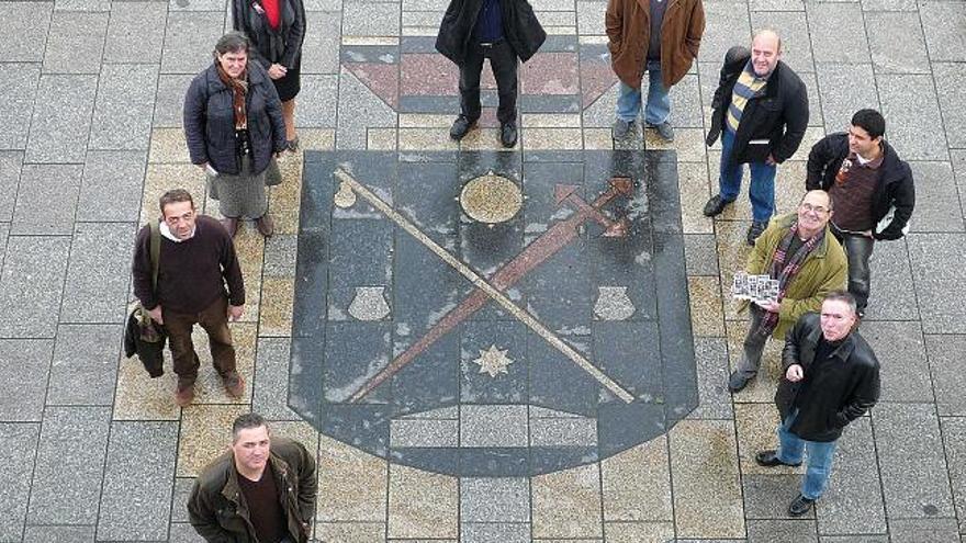 Miembros del colectivo Abrenoite con la alcaldesa entorno al escudo de Cangas.