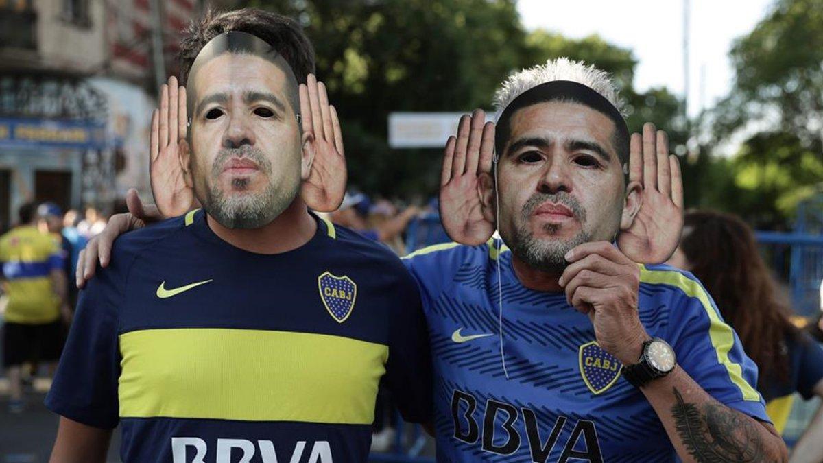 Seguidores de Boca Juniors usando caretas de Juan Román Riquelme antes de un partido en la Bombonera