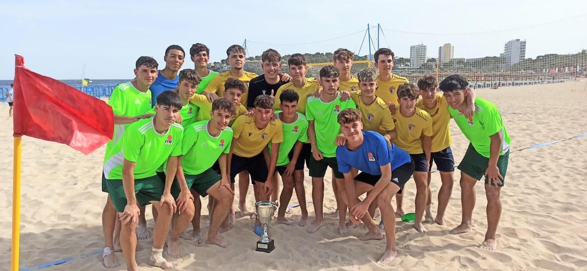 La selección balear de fútbol sala juvenil y el La Salle juvenil posan con la copa del torneo de fútbol playa jugado en Magaluf.