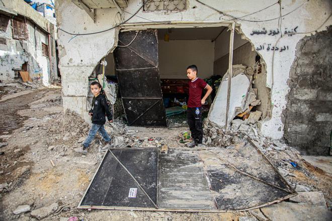 Dos niños caminan por los escombros dejados por un ataque israelí en un campo de refugiados de Cisjordania.