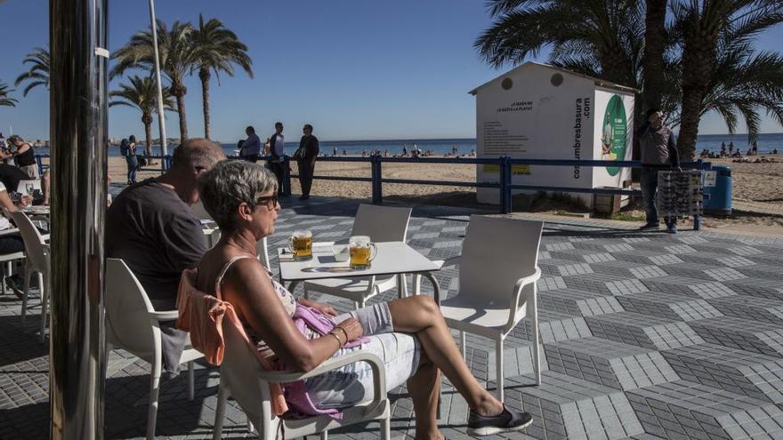 Turistas disfrutando de temperaturas primaverales en la antesala del invierno en el paseo del Postiguet en Alicante