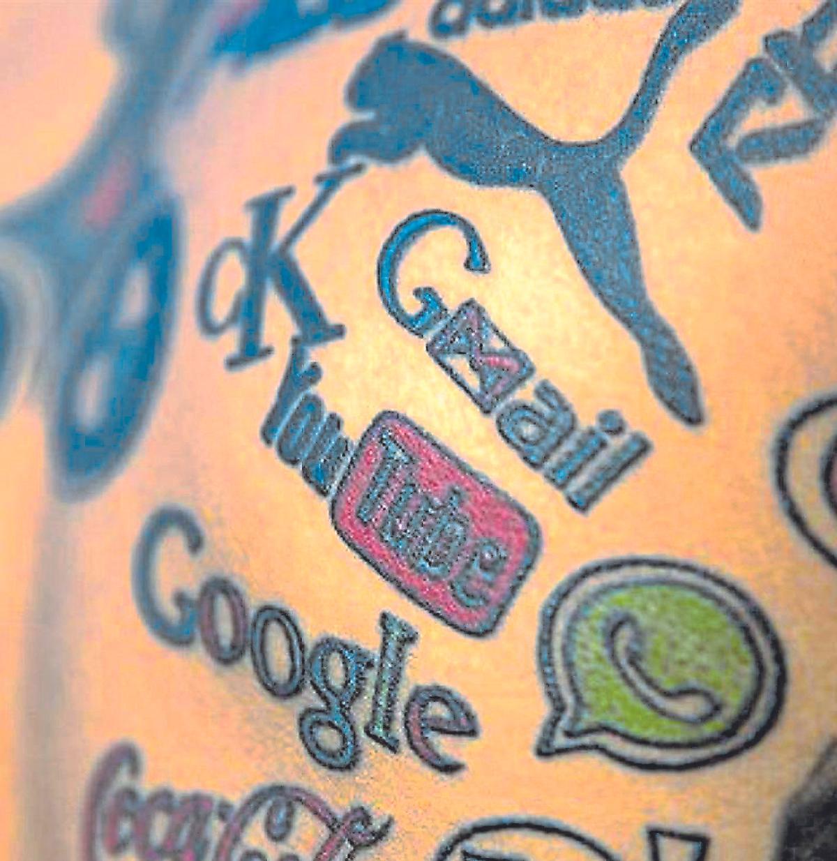 Logos de marcas tatuados en la espalda de un joven indio.