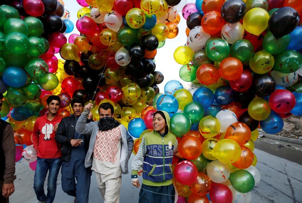 Men hold balloons for sale during Afghan spring ...