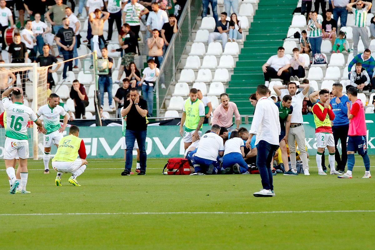 Los futbolistas y cuerpo técnico del Córdoba CF, desolados tras el desvanecimiento de Gudelj.