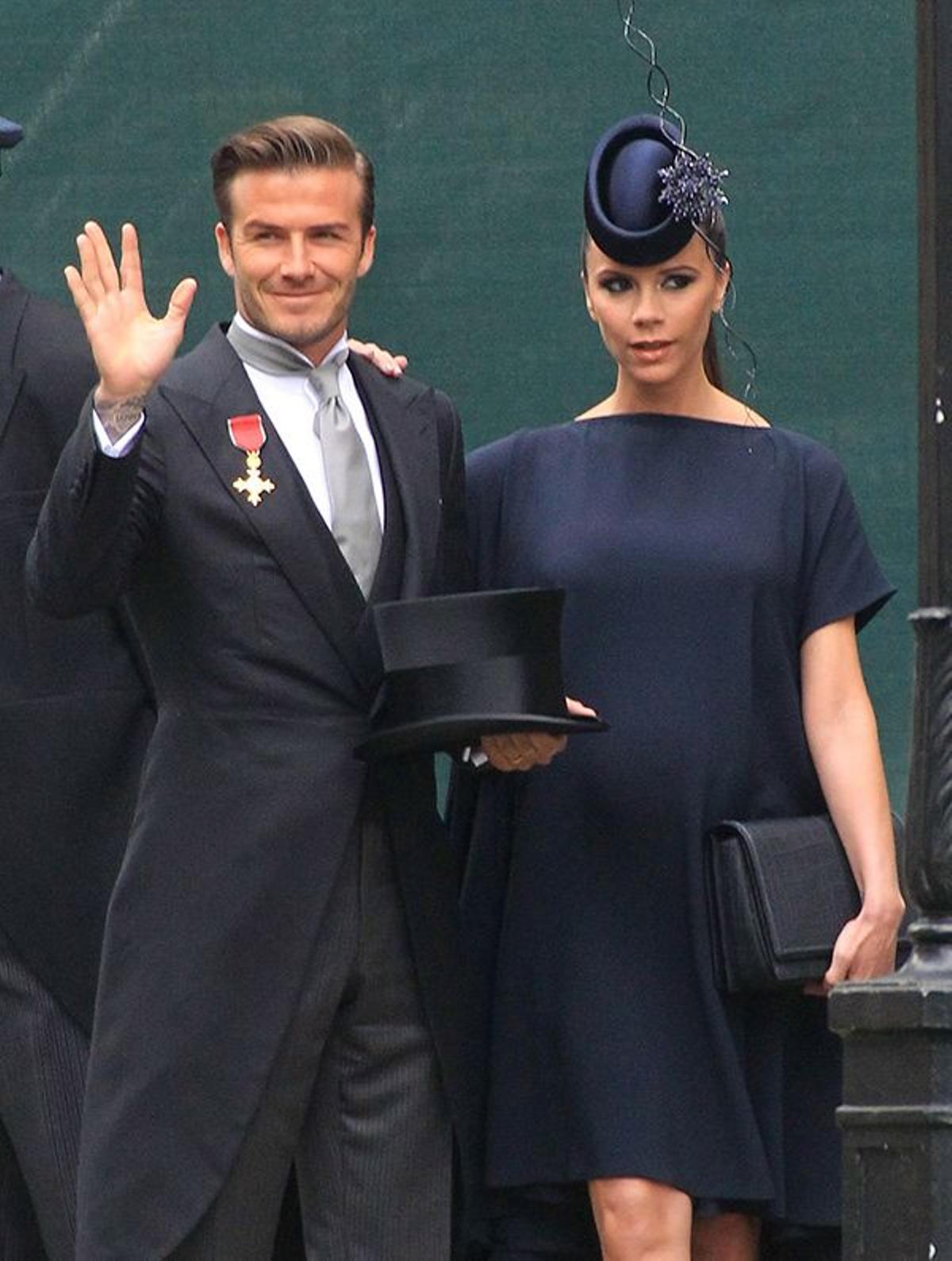 David y Victoria Beckham, con sombrero y tocado de Philip Tracy