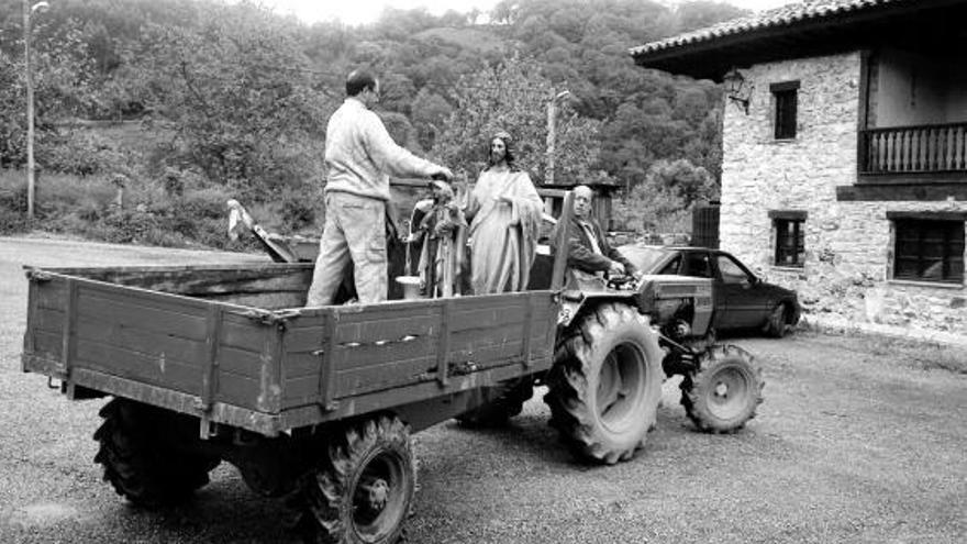 García (al volante) y Aquilino Bustelo, trasladando en tractor las figuras de la capilla durante las obras.