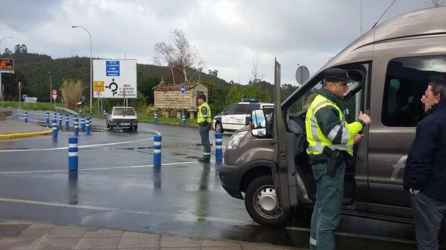 Un agente de la Guardia Civil de Tráfico en el momento de inmovilizar un microbús ilegal rumbo a Alvedro.