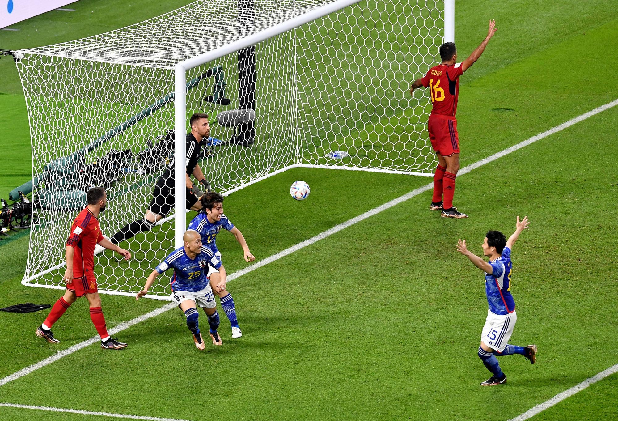 Japan's Ao Tanaka celebrates scoring their second goal with Daizen Maeda and Daichi Kamada