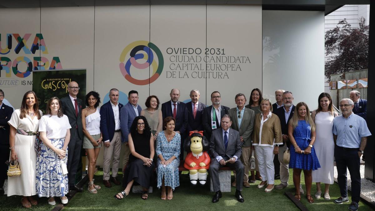 Junto a Mafalda, la consejera de Cultura, Vanessa Gutiérrez; la alcaldesa de Gijón, Carmen Moriyón y el alcalde de Oviedo, Alfredo Canteli durante el día de la ciudad en Fidma en 2025. Les rodean los concejales Alejandra González, Sonsoles Peralta, Jorge García Monsalve, Natalia Sánchez Santa Bárbara, Daniel Tarrio y José Ramón Pando; la presidenta de la Federación Asturiana de Concejos, Cecilia Pérez; el presidente de la Junta General del Principado, Juan Cofiño; el alcalde de Langreo, Roberto Marcos; los concejales José Ramón Pando, Covadonga Díaz y  Charo Suárez; el director de Fidma, Álvaro Alonso y los ediles Alfredo García Quintana, Elena Figaredo, Lourdes García y Gaspar Llamazares.